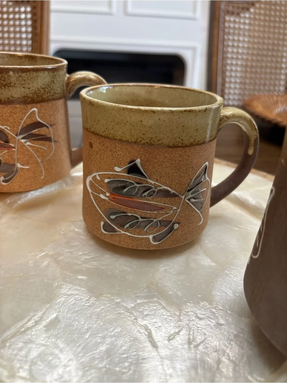 Three vintage stoneware pottery mugs with hand painted fish